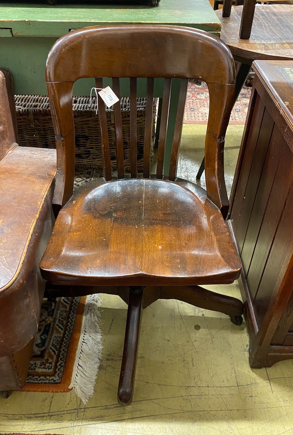 An early 20th century American walnut swivel desk chair, by the Marble and Shattuck Chair Co, Cleveland, width 49cm, height 88cm